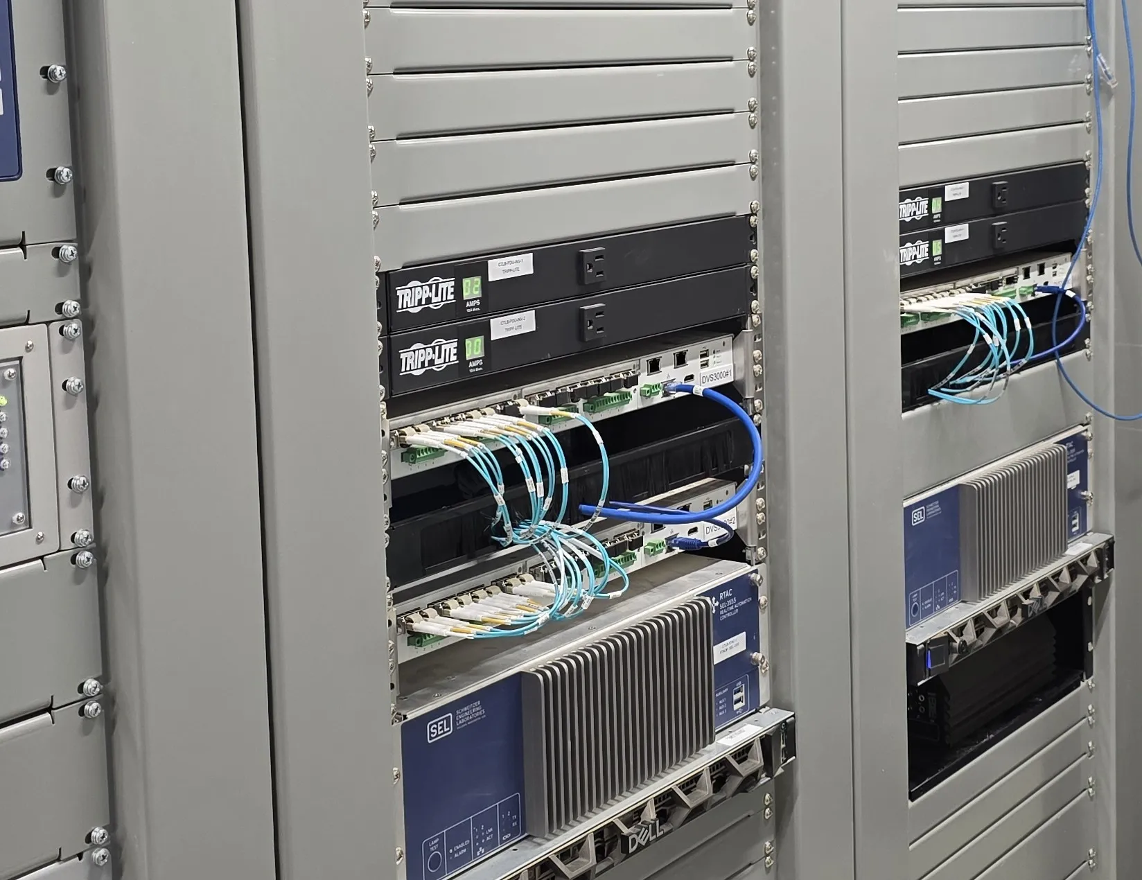 Data center rack with Tripp Lite power modules, SEL units and organized blue fiber optic patch cables